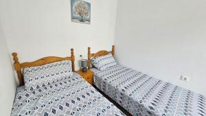 two beds sitting next to each other in a bedroom at Villa Nina in Mazarrón +39 photos