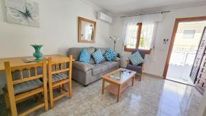 a living room with a couch and a table at Villa Nina in Mazarrón