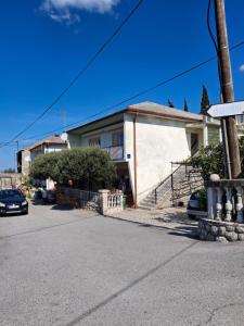a house with a car parked in front of it at Edo Apartman 1 in Senj
