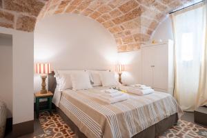 Ένα ή περισσότερα κρεβάτια σε δωμάτιο στο MASSERIA STELLA DEL CARRUBO - Apulian luxury House & Sea View +78 φωτογραφίες