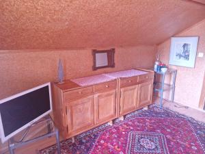 a room with a flat screen tv and a tv stand at Traditional Ski Chalet in Wengen - Top Floor in Wengen