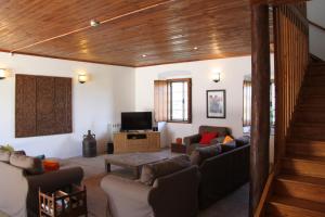 a living room with two couches and a television at Quinta Dos Ribeiros in Alpalhão