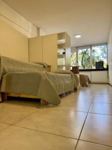 a bedroom with two beds and a television in it at Departamento Independencia in Buenos Aires +9 photos