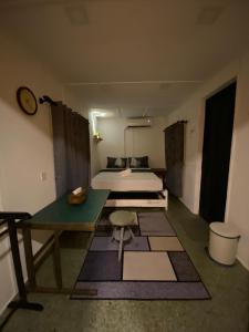 a room with two beds and a table and a bed at Pok Mat Beach Cabin in Marang +71 photos