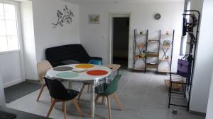 a living room with a table and chairs at La petite maison in Mézières-en-Brenne