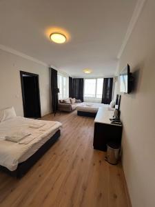 a bedroom with a bed and a living room at KOLİBRY Sv HOTEL in Antalya