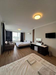 a hotel room with two beds and a flat screen tv at KOLİBRY Sv HOTEL in Antalya +48 photos