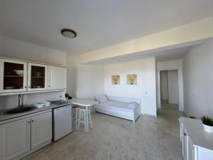 a kitchen and living room with a couch and a table at Tao Te Wellness in Polychrono