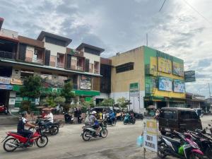 a group of people riding motorcycles down a street at Rielena Plaza Hotel and Suites in Molave