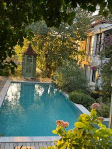 a swimming pool in a yard with a gazebo at Maison Blanche in Nîmes +15 photos