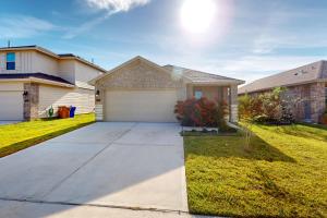 a house with a driveway and a garage at The Seashell House in Corpus Christi