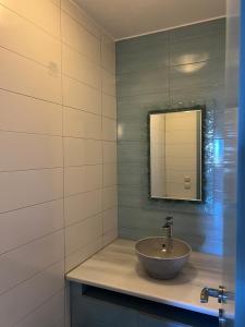 a bathroom with a sink and a mirror at Areopoli Home 17 in Areopolis