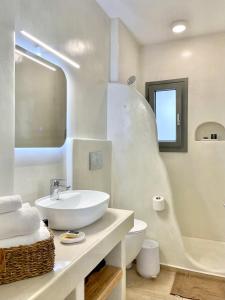 a white bathroom with a sink and a toilet at Luaz Naxian living in Naxos Chora +49 photos