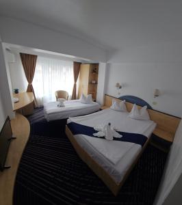 Postel nebo postele na pokoji v ubytování BRIZA Boutique Hotel Mamaia