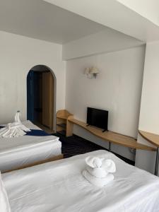 Postel nebo postele na pokoji v ubytování BRIZA Boutique Hotel Mamaia