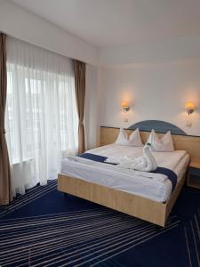 Postel nebo postele na pokoji v ubytování BRIZA Boutique Hotel Mamaia