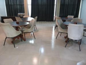 a group of tables and chairs in a room at Hotel S R in Lucknow