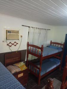 a bedroom with two bunk beds and a window at Pousada & Camping Santa Clara in Santa Helena
