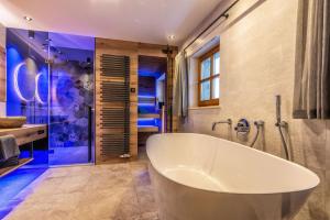 a large bathroom with a tub and a shower at Edlgütl - Hideaway in Breitenberg +74 photos