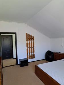 a room with a bed and a black door at La Dunare in Crisan +7 photos
