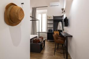 a living room with a table and a desk at Style & Stone Guest House in Rome