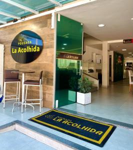 a lobby with a sign for a la acatalilla at Pousada La Acolhida in Cabo Frio