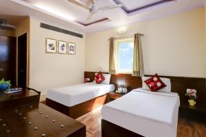 Ένα ή περισσότερα κρεβάτια σε δωμάτιο στο The Pearl- A Royal Residency