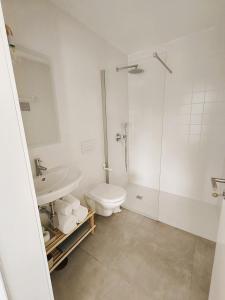 a bathroom with a toilet and a shower and a sink at FlorAL in Aljezur +33 photos