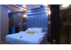 a bedroom with a large white bed in a room at Grand Diamond Hotels & Suites LTD in Owerri