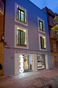 a building with a sign on the side of it at Sant Jordi Hostels Gracia in Barcelona