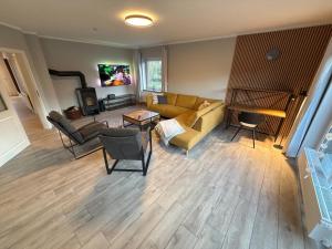 a living room with a couch and a table at "Bauernhof-Claussen" - Haus Inseltraum in Fehmarn