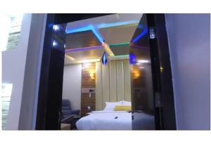 a hotel room with a bed and a mirror at Grand Diamond Hotels & Suites LTD in Owerri