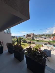 a group of potted plants sitting on top of a building at Maya Suites Potidaia in Nea Potidaea