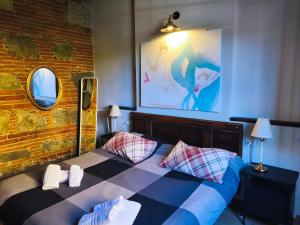 a bedroom with a bed with two pillows on it at B&BIG LUCCA in Lucca