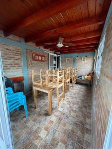 a patio with a wooden table and chairs at Hotel Altas Cumbres in Villa Carlos Paz +21 photos