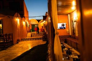 a hallway of a building with tables and chairs at Fenti Nubian Resort in Aswan