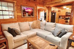 a living room with a large couch in a cabin at Bearfoot Bend Cabin in Blue Ridge in Blue Ridge
