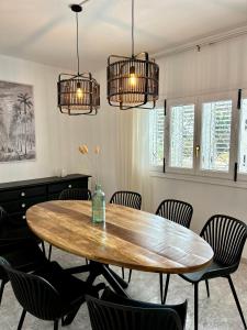 a dining room with a wooden table and chairs at Amazing Finca With Pool & Forest - 4BR - Walk to UNVRS and AMNESIA in San Antonio