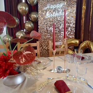 a table with a happy birthday sign and red candles at Къща за гости Куклите Петревене in Petrevene