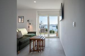 a living room with a couch and a table at LUMANIS Foro Romano in Zadar