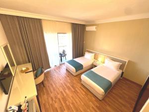 Voodi või voodid majutusasutuse Hotel Méditerranée Beyrouth toas