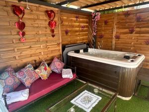 a room with a bath tub and a bench with pillows at Loft con SPA exterior climatizado Villa IRI in Pineda de Mar +20 photos