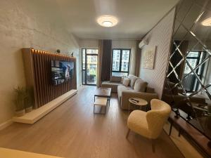a living room with a couch and a tv at Luxury Escape in Belgrade Waterfront in Belgrade
