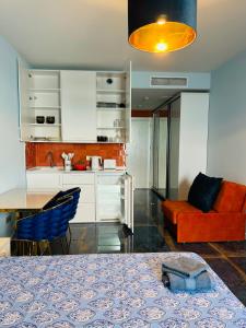 a kitchen and living room with a table and a couch at Bamboo Beach Tsikhisdziri Seaview Flat 839 in Tsikhisdziri