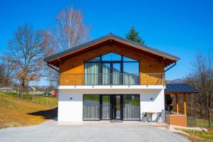 a house with a balcony on top of it at EDEN HOUSE Viseu de Sus in Vişeu de Sus