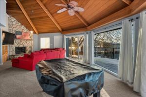 a living room with a red couch and a ceiling fan at Private Beach, Close To Everything in South Lake Tahoe