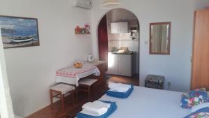 a room with a kitchen with a table and a kitchen at Adrion Zvg in Živogošće
