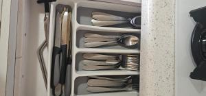 a drawer full of utensils in a cabinet at Las Julies's Apartment in Arenales