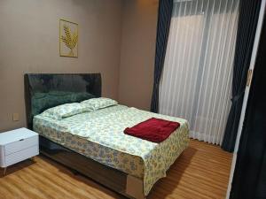a bedroom with a bed with a red towel on it at Papi Villa O3 in Tlekung +15 photos