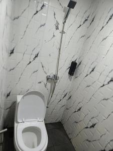 a white bathroom with a toilet and a shower at Papi Villa O3 in Tlekung
